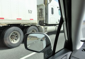 The righthand-side blindspot next to a semi truck and trailer.