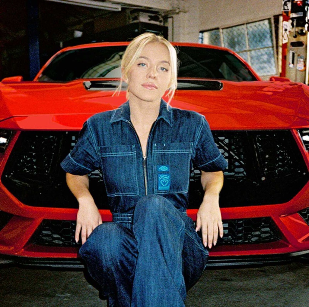 Popular celebrity Sydney Sweeney sits with a 2024 Ford Mustang in car commercial.