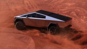 The Tesla Cybertruck driving through sand