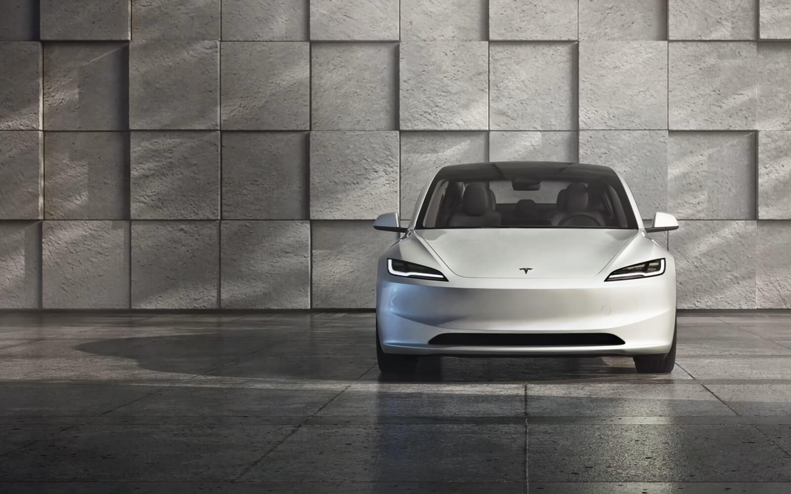 A new white Tesla Model 3 shows off its front-end styling. 