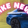 A blue BMW car's right rear quarter with the words "LIKE NEW!" in neon pink