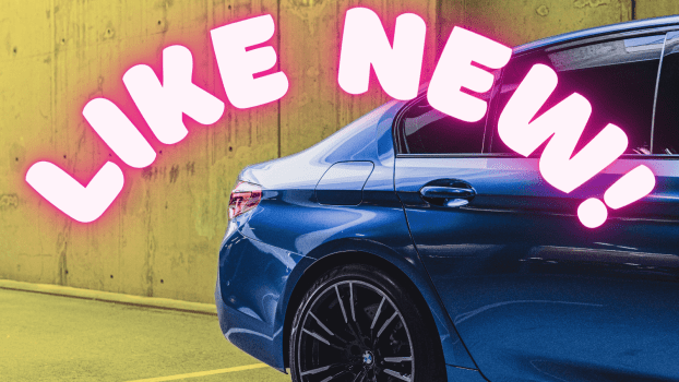 A blue BMW car's right rear quarter with the words "LIKE NEW!" in neon pink