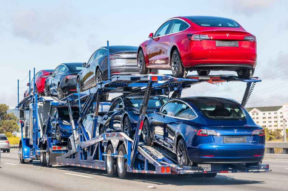 A fully stocked car transport truck carries eight Tesla sedans