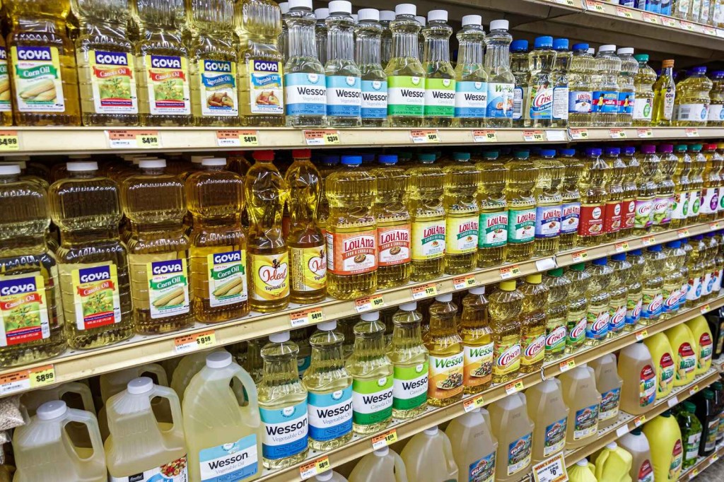 Shelves of bottled oils at a grocery store