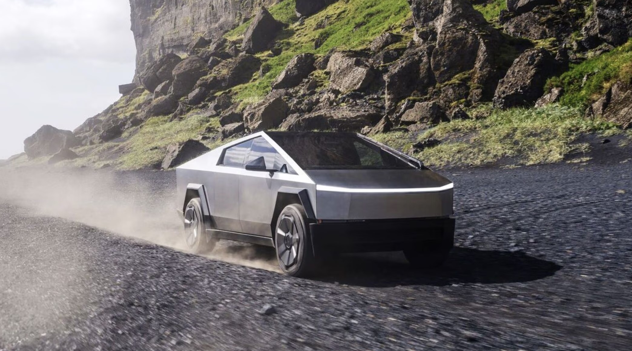 The Tesla Cybertruck driving on gravel