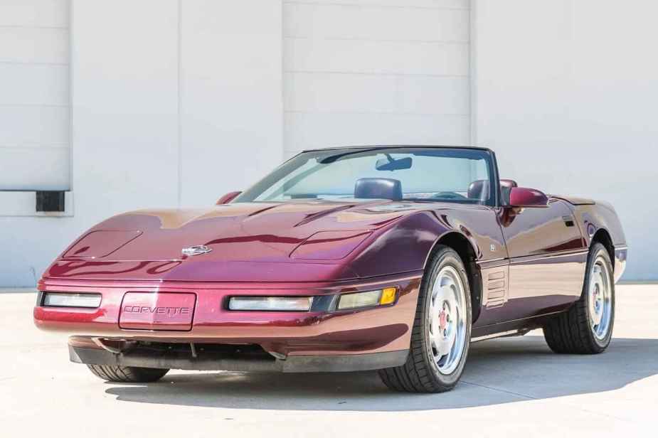 A maroon 1993 Chevrolet Corvette 40th Anniversary Edition parked with top off in left front angle view