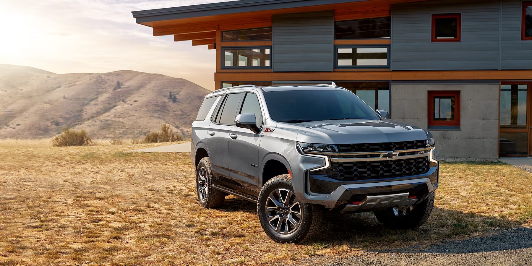 The 2024 Chevy Tahoe near a home