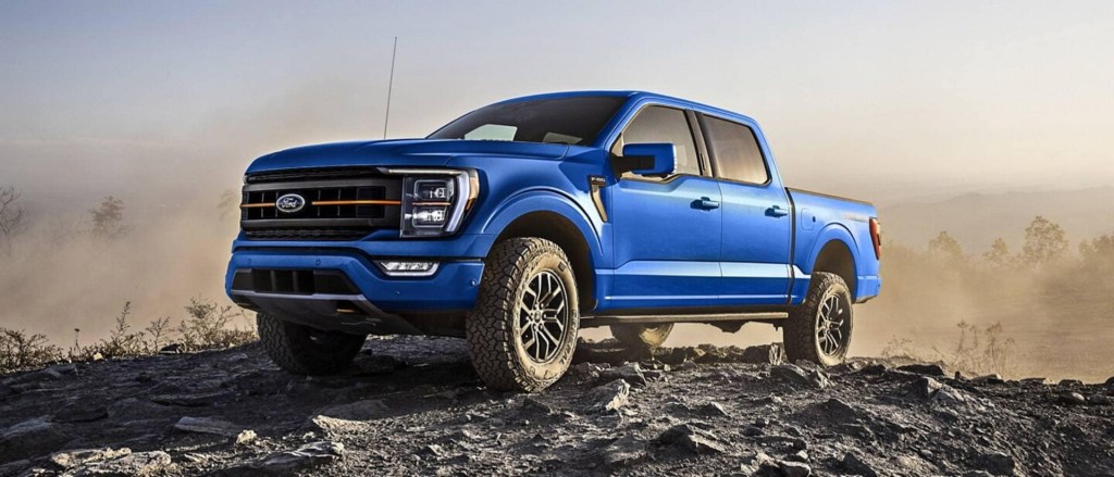 The 2024 Ford F-150 Hybrid climbing over rocks