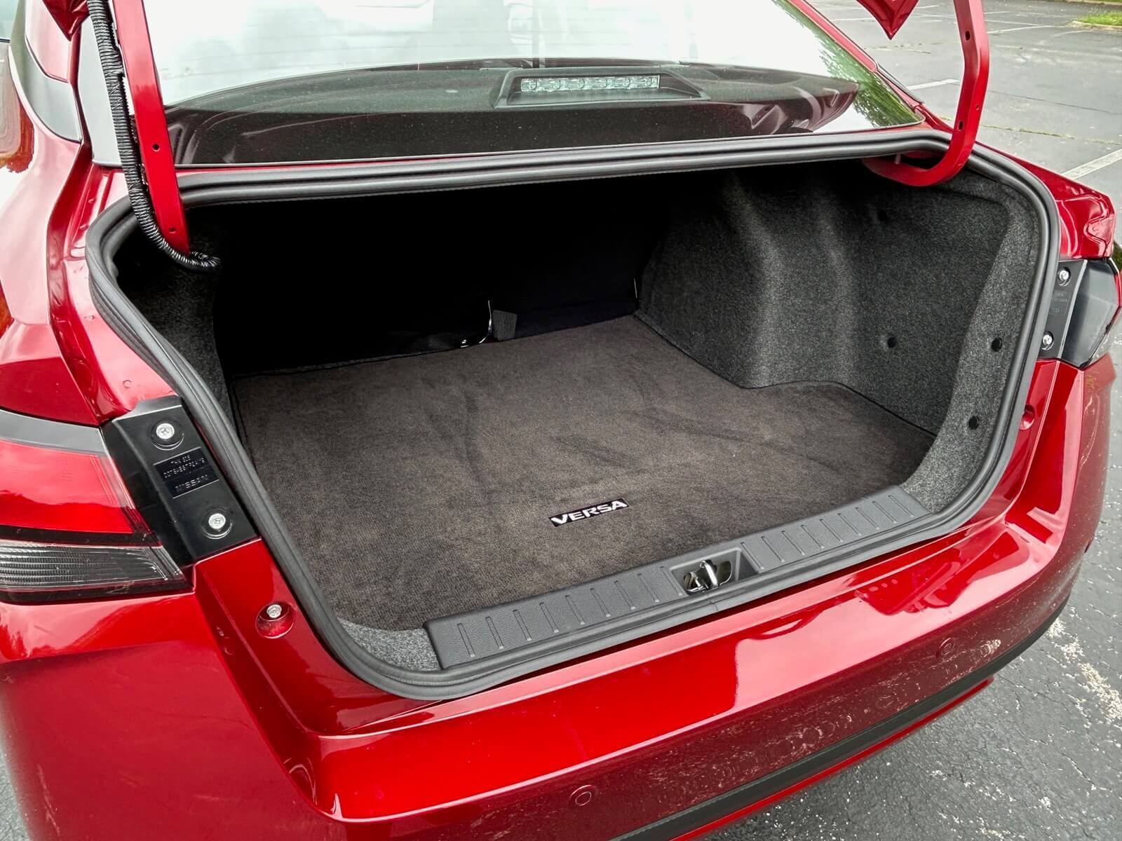 The Nissan Versa SR shows off its trunk space and floor mat.