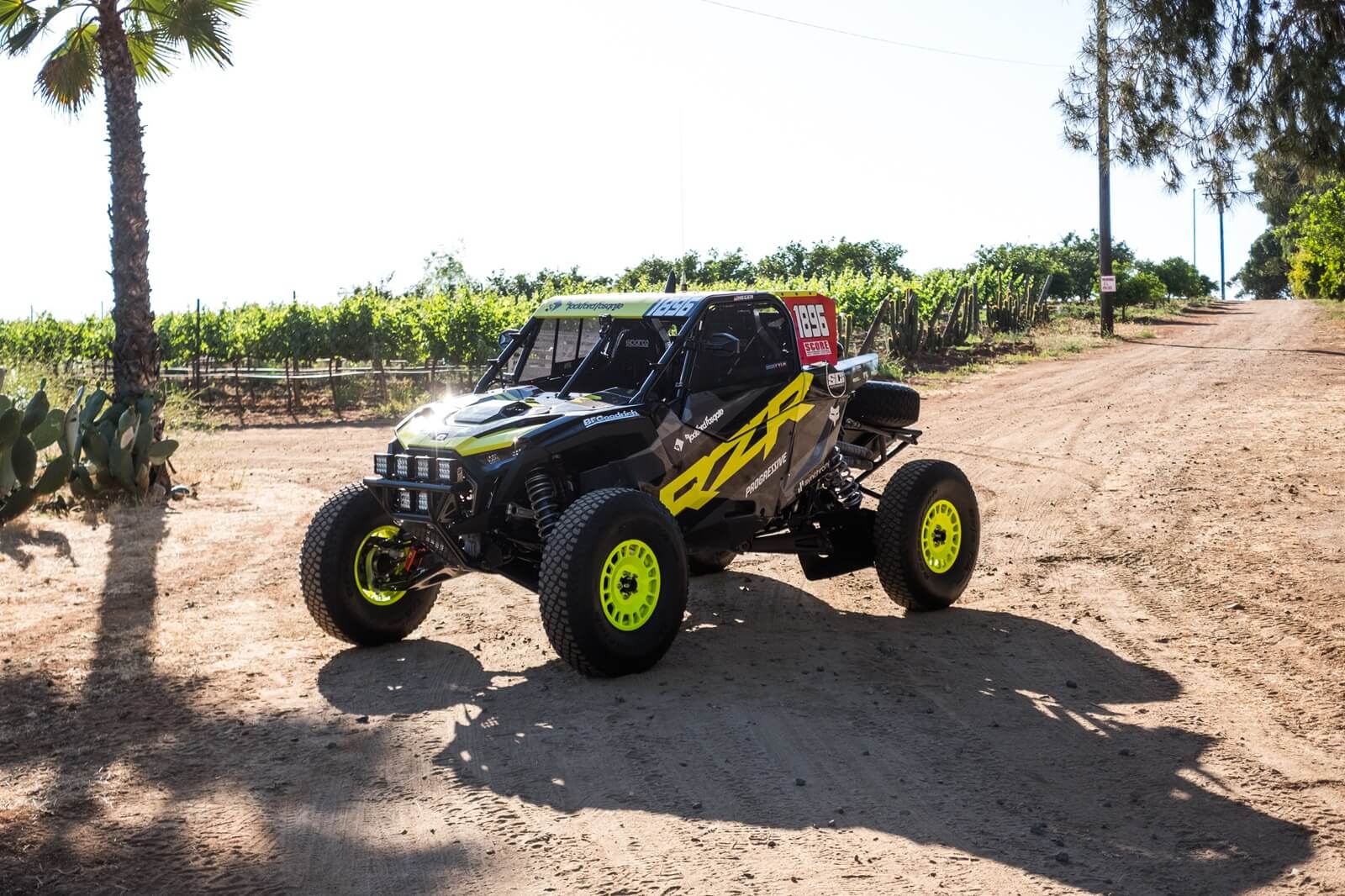 A yellow Polaris RZR Pro R Factory model in the sun.