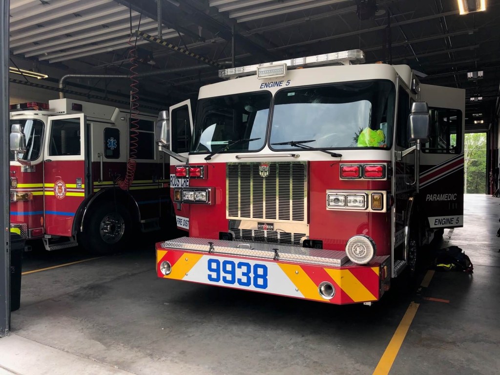 A fire truck siren sits on the driver-side portion of its bumper.
