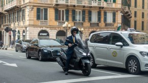 A man riding a moped in the city