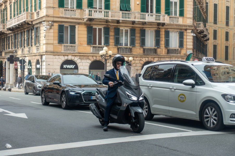 A man riding a moped in the city