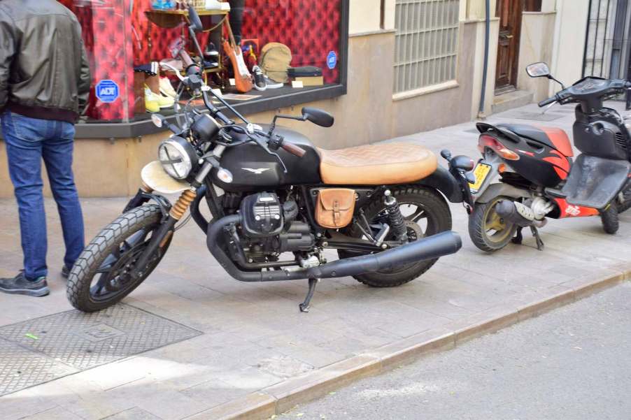 Moto Guzzi cafe racer parked on the sidewalk in Spain