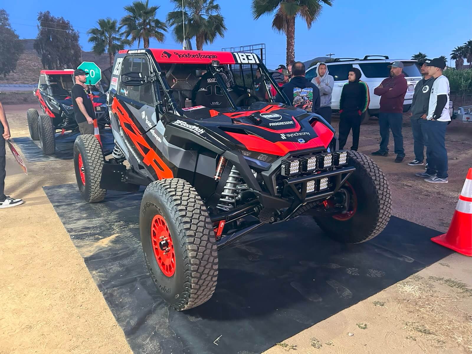The Polaris Factory Racing team performs pit drills into the night. 