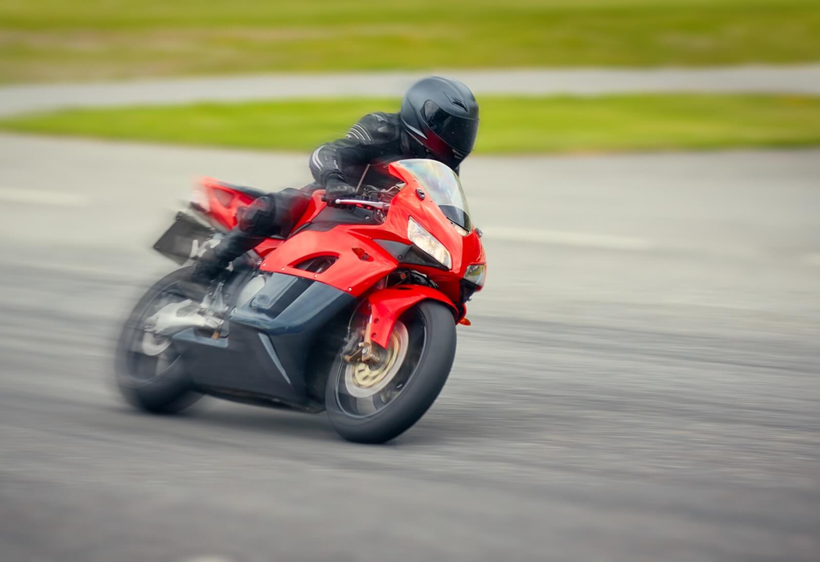 A sportbike rider speeding on a track. 