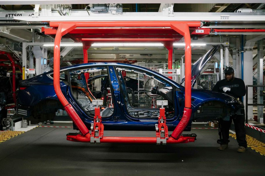 A man assembles a Tesla Model Y at the automaker's Fremont factory.