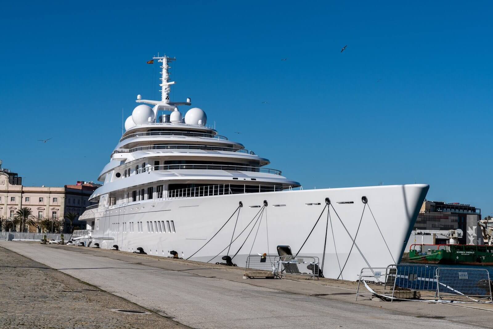 The mega yacht known as Azzam is moored at a harbor. 