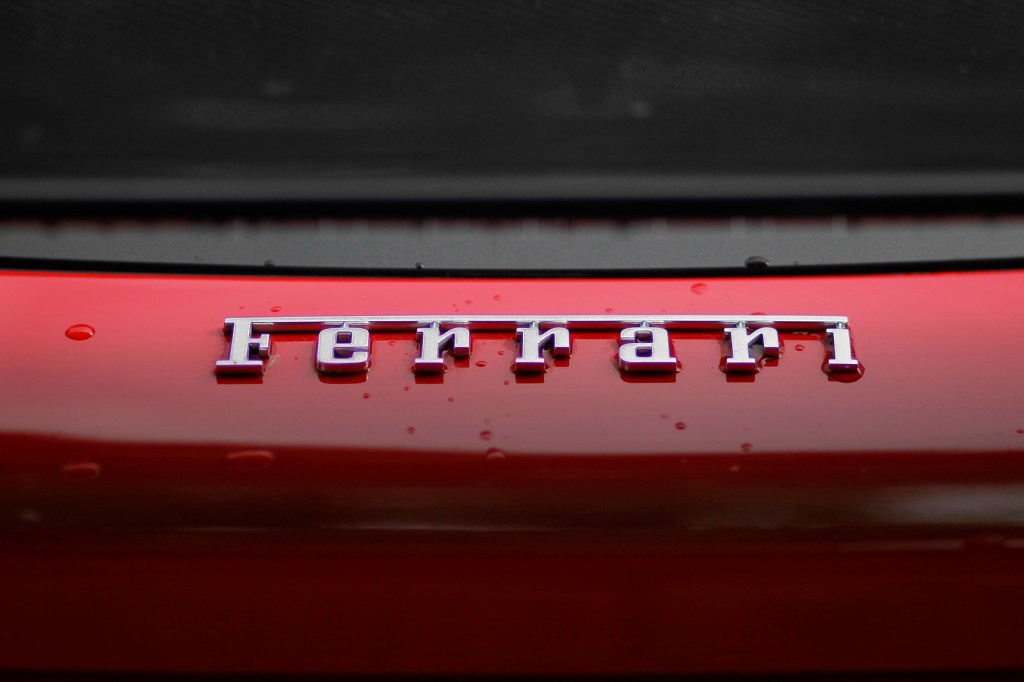 Ferrari lettering on a red car the Ferrari EV is rumored to start at over half a million dollars