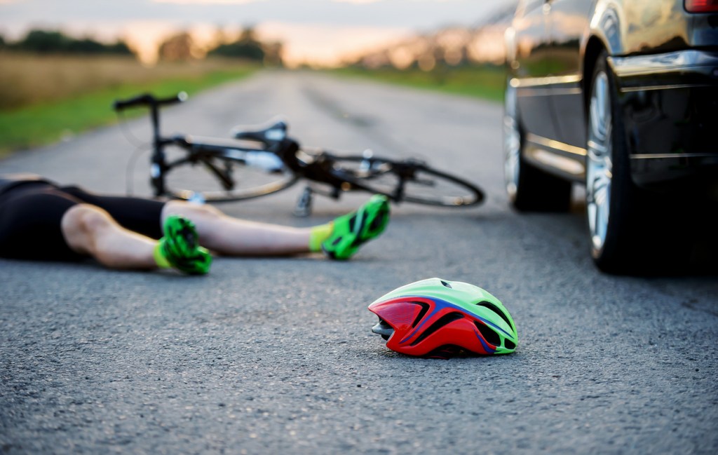 A bicyclists on the road after being hit
