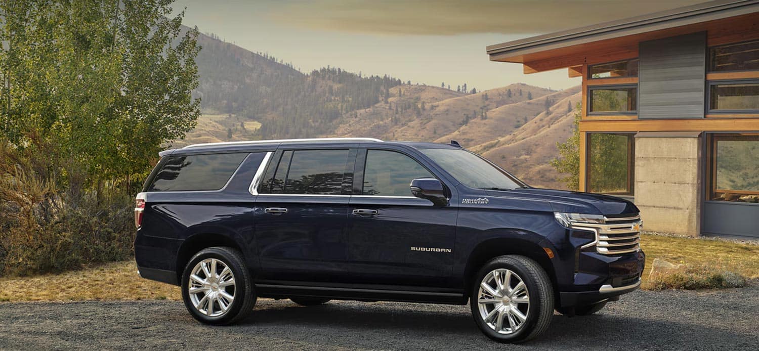 A 2024 Chevy Suburban parked near a home