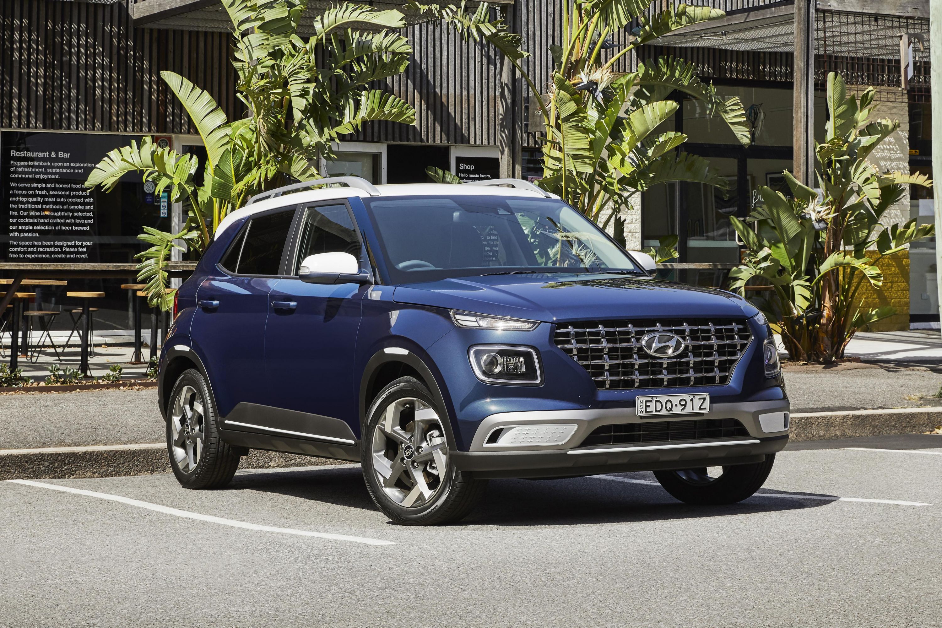 The 2024 Hyundai Venue parked near banana trees