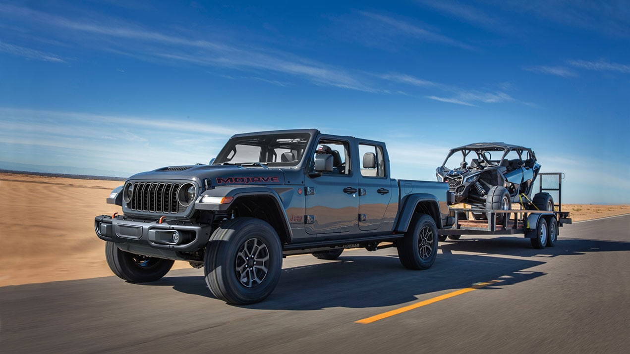 The 2024 Jeep Gladiator  towing an ATV