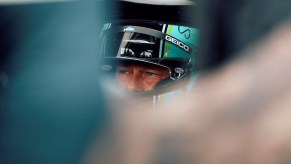 Brad Pitt in a race car filming F1 at the British Grand Prix.