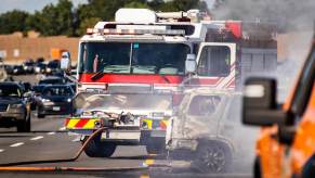 A fire department engine responds to car damage and fire after a motor vehicle accident.