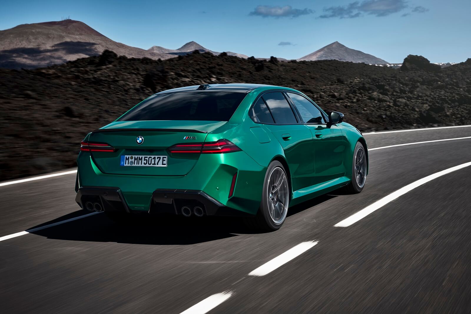 A green 2025 BMW M5 shows off its rear-end styling.