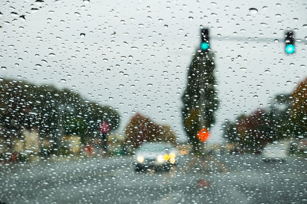 The view through a windshield on a rainy day