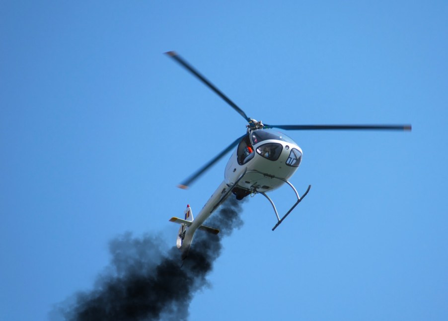 A small rotary-wing aircraft billows smoke as it fights becoming another helicopter crash statistic.