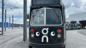 Black train in Boston with goofy googly eyes painted on the fornt.