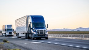 Two semi trucks on the road