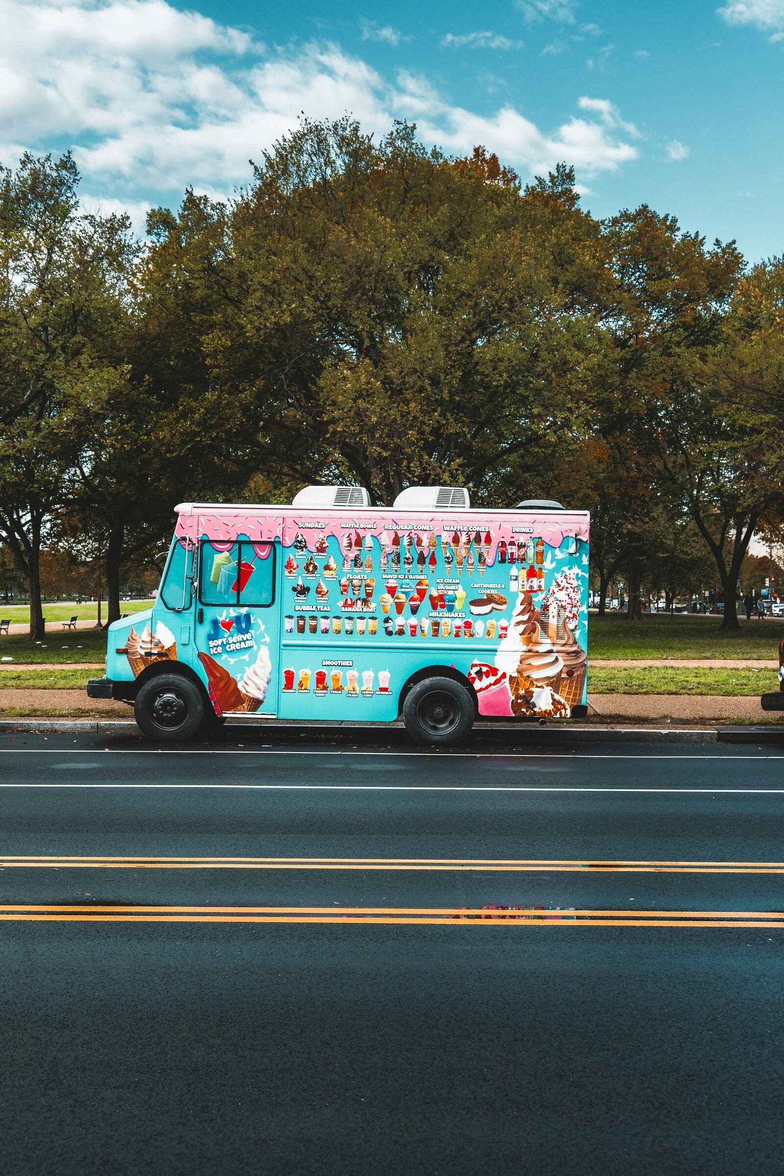 An ice cream truck parked in left profile view