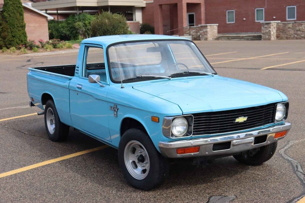 A blue 1980 Chevrolet LUV compact truck parked in right front angle view in a parking lot