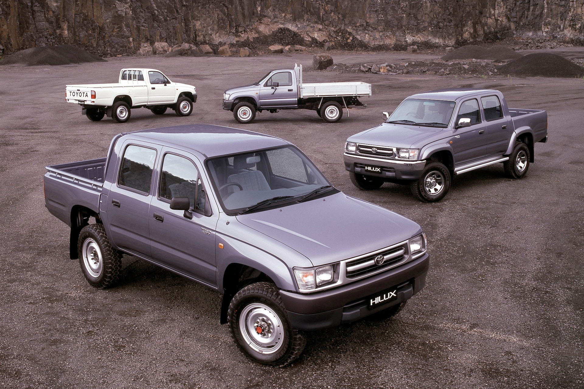 1990s Toyota Hilux models parked in dirt