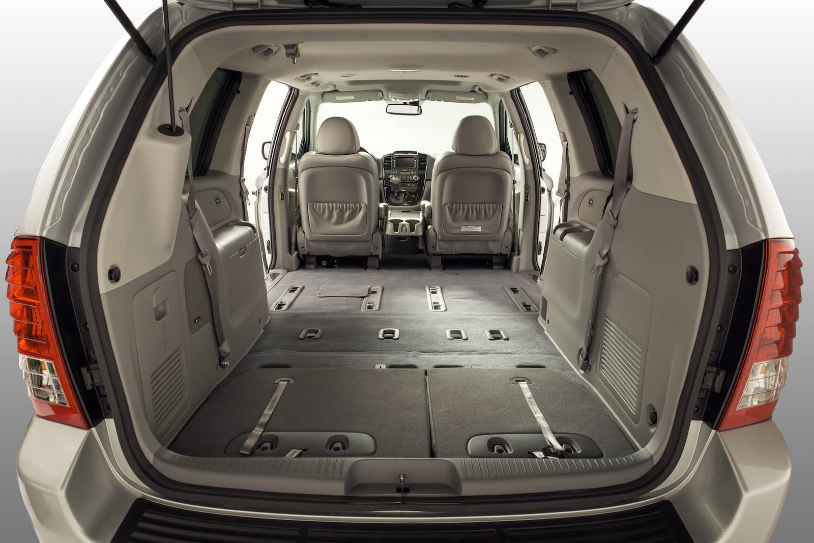 The tan interior of a beige Sedona minivan