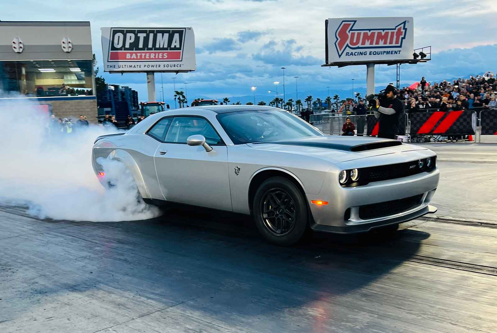 A silver 2023 Dodge Challenger SRT Demon 170 smokes tires on a drag racing track