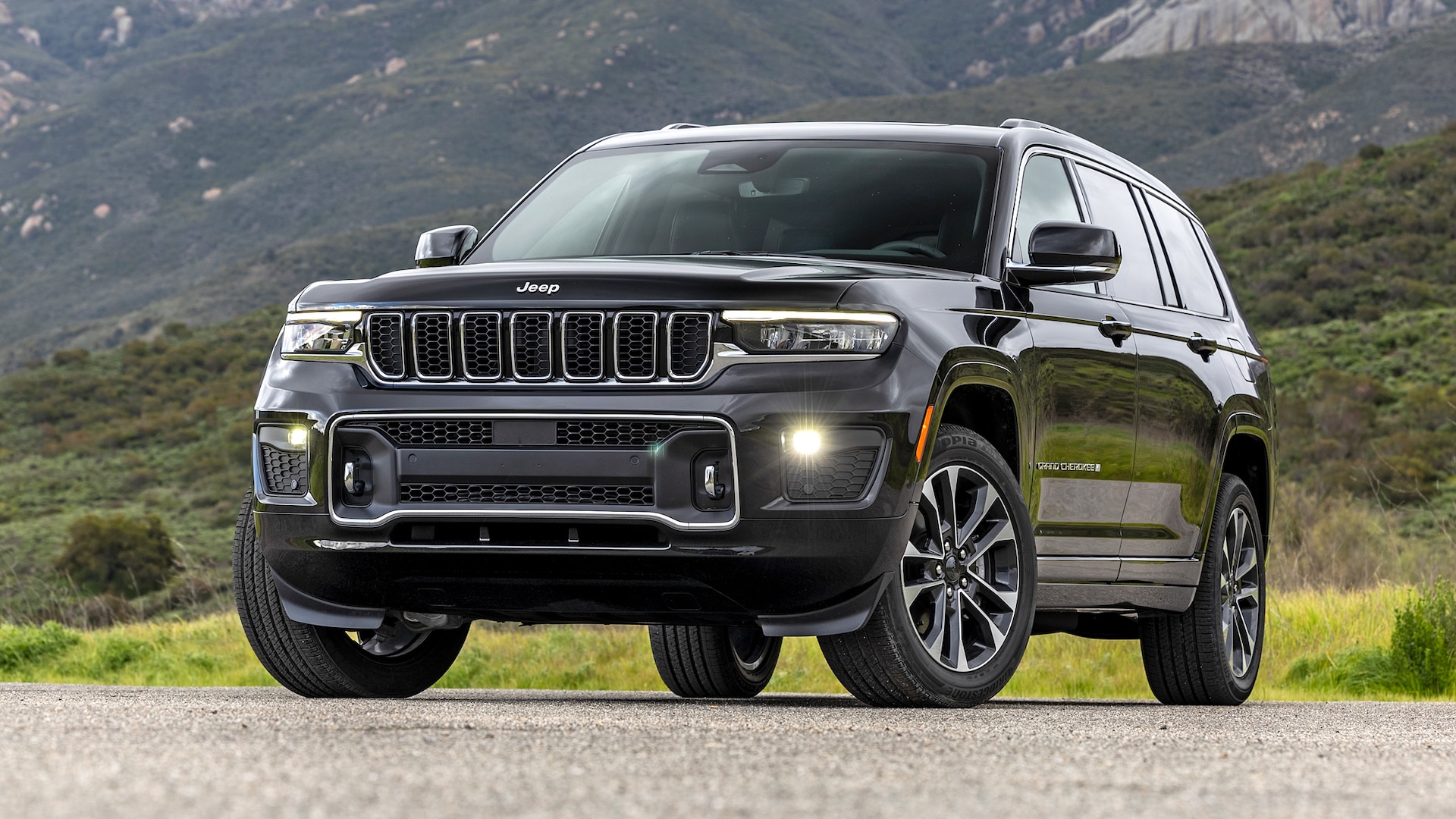 The 2024 Jeep Grand Cherokee parked near a mountainous view