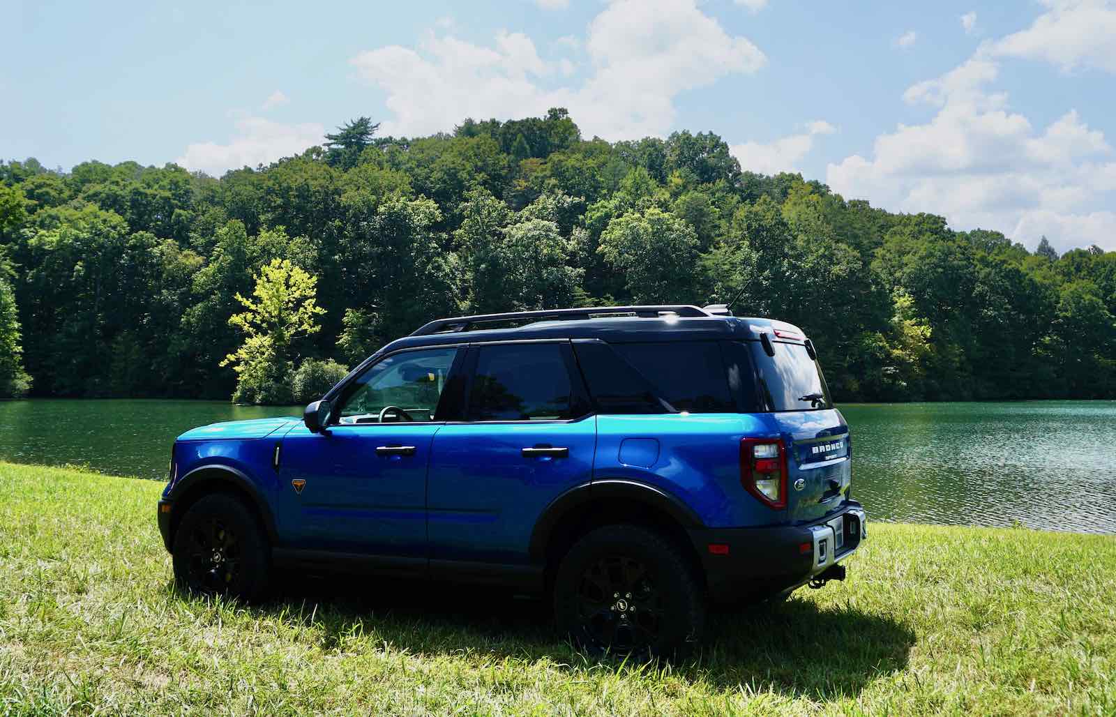 Blue Ford Bronco Sport parked by a lake.
