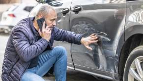 A driver calls to make a car insurance claim after a sideswipe crash.