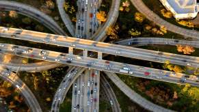 An aerial view of a cars driving on a highway system in the United States.