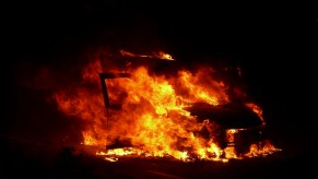 Orange fireball consuming an EV car that's burning
