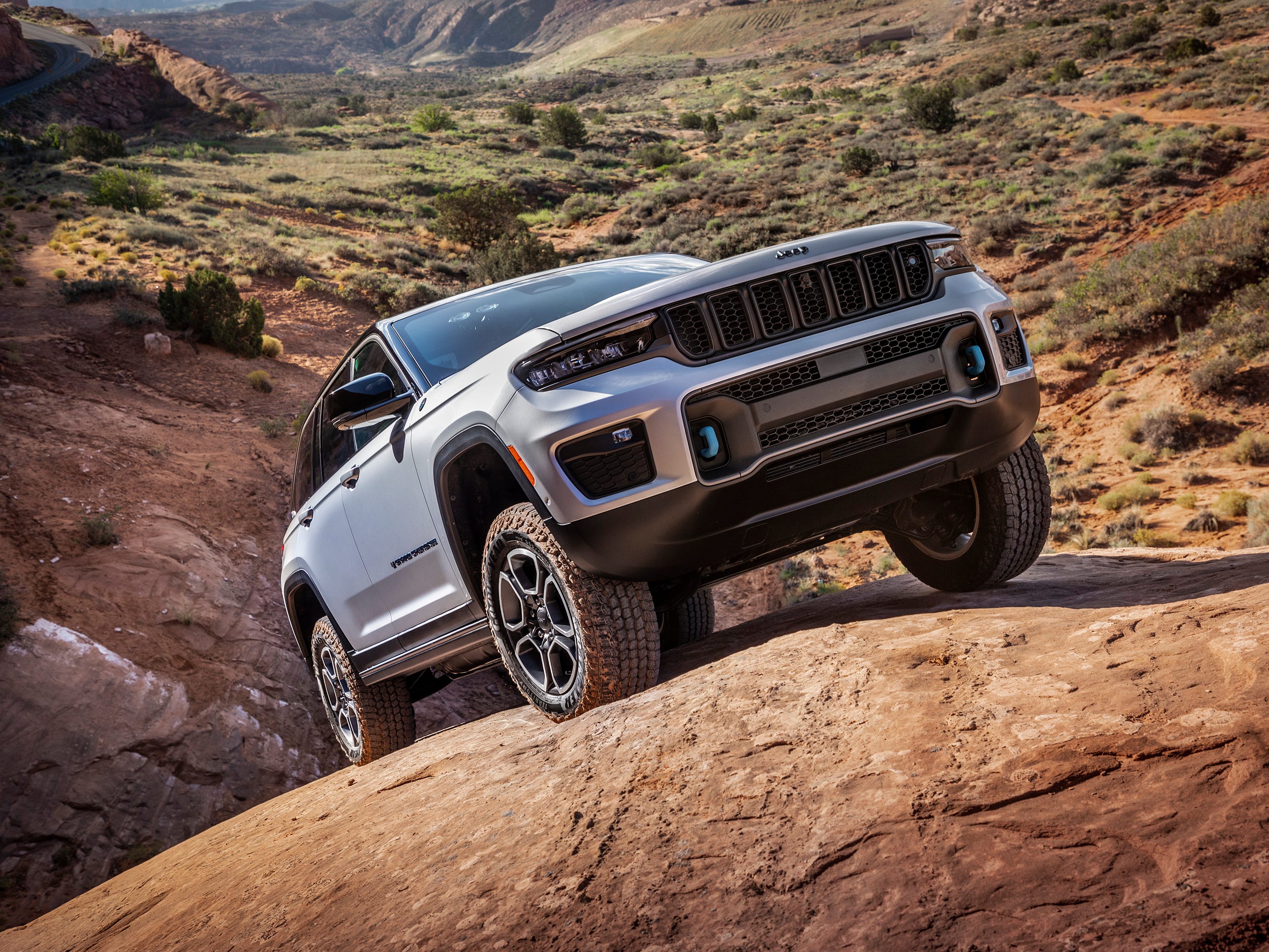 The 2024 Jeep Grand Cherokee 4xe climbing over rocks