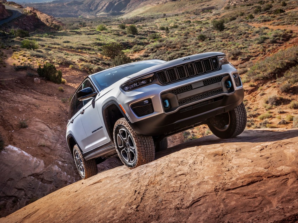 The 2024 Jeep Grand Cherokee 4xe climbing over rocks