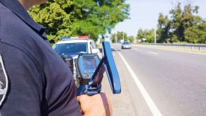 A police officer runs a speed trap to combat drivers who may have laser jammers or radar jammers.
