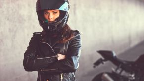 A disappointed motorcycle rider with arms folded, likely after being followed by a tow truck.