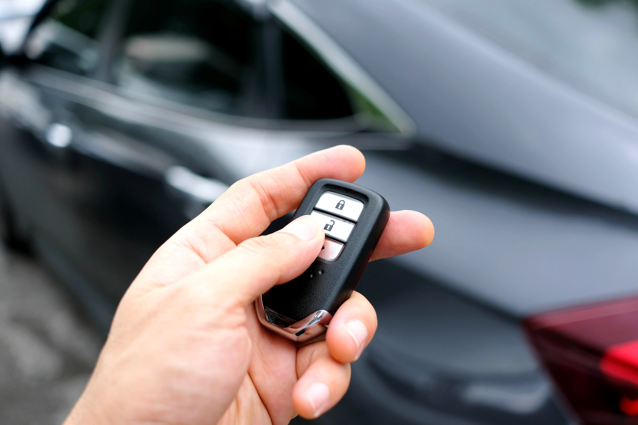 A man holding a car key fob 