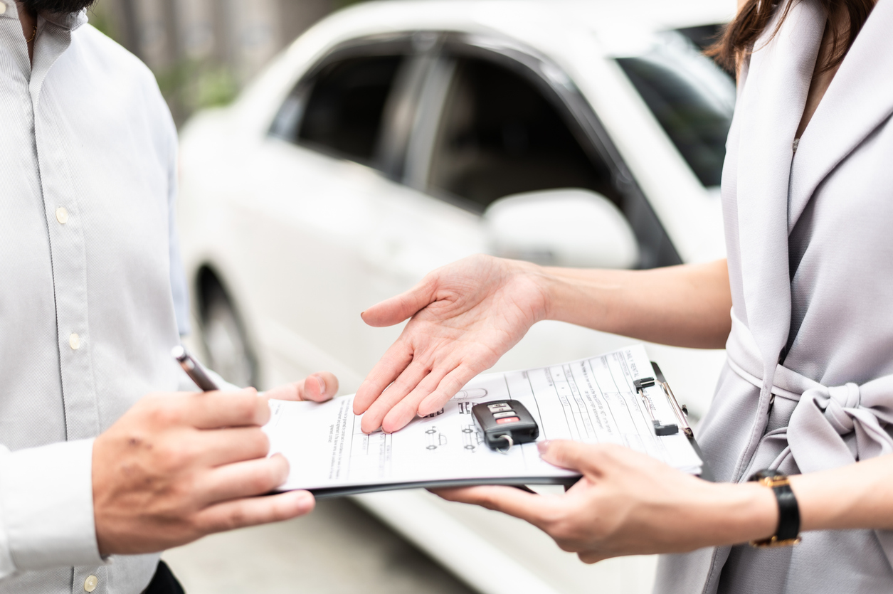 A man buying a car from a woman